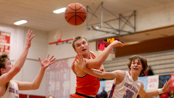 Sprague's Teagan Quitoriano (14) and South Salem's Tyler Wadleigh (11) and Ryan Brown (30) all reach for a rebound in the second half of the Sprague vs. South Salem boy's basketball game at South Salem High School on Friday, Feb. 3, 2017. Sprague won the game 64-58.
