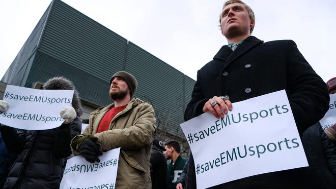 Students, athletes, faculty and alumni listen to a speaker during a rally to save Eastern Michigan University sports on Monday, April 17, 2018, outside the EMU Convocation Center in Ypsilanti.