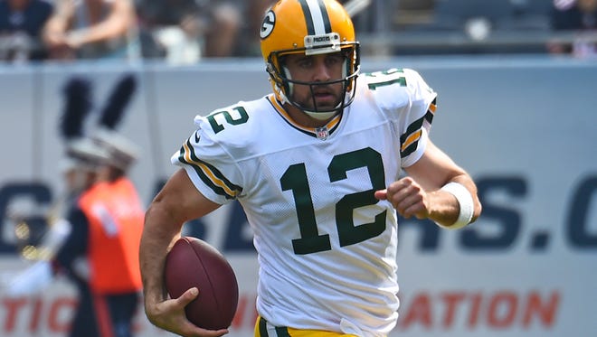 Green Bay Packers quarterback Aaron Rodgers rushes the ball against the Chicago Bears during the second half at Soldier Field.