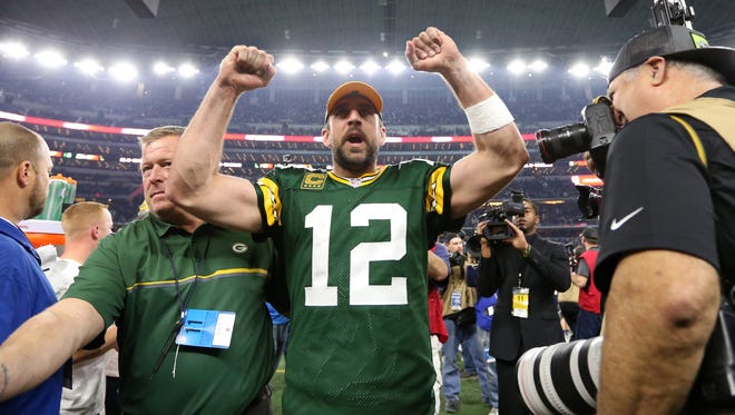 Green Bay Packers quarterback Aaron Rodgers celebrate after beating the Dallas Cowboys on Sunday.