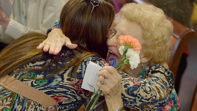 Melody Willis receives a hug from Elmcroft resident Inez after receiving fresh flowers provided by Senior Flower Partners, Wednesday. Senior Flower Partners is a nonprofit organization kicked off by Senior Solutions Home Care's Murfreesboro branch. Members of the Jackson office passed out flowers to residents at Elmcroft Assisted Living Facility.