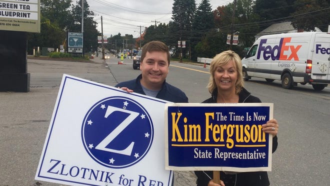 State Rep. Jon Zlotnik, D-Gardner, and state Rep. Kim Ferguson, R-Holden, hold campaign signs in 2018.