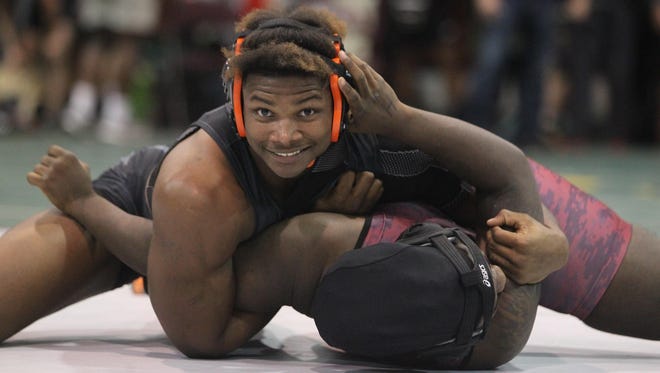 Cam Brown smiles for the camera while calmly pinning his opponent during the Capital City Classic this past season.