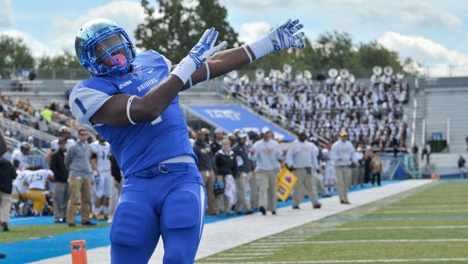 Oct 4, 2014; Murfreesboro, TN, USA; Middle Tennessee Blue Raiders running back Shane Tucker (1) celebrates after scoring a touchdown against the Southern Miss Golden Eagles during the first half at Floyd Stadium. The Blue Raiders won 37-31. Mandatory Credit: Jim Brown-USA TODAY Sports