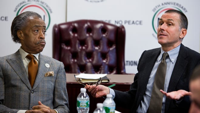 Al Sharpton, left, listens as he meets with Mark Lee, CEO of Barneys New York, on Tuesday in New York City.