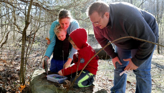 Holly and Drew Tyrer and their sons Hudson, left, and Brookman, right, open up a geocache they located hidden under a rock at the Owl's Hill Nature Sanctuary in 2015. Owl's Hill Nature Sanctuary was one of the nonprofits to receive grant money from the Community Foundation of Middle Tennessee this year.