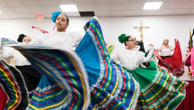 Latino families watch the traditional Mexican Mariachi dance during the Hispanic Heritage Month at St. Catherine of Siena Parish Catholic Church in South Phoenix.