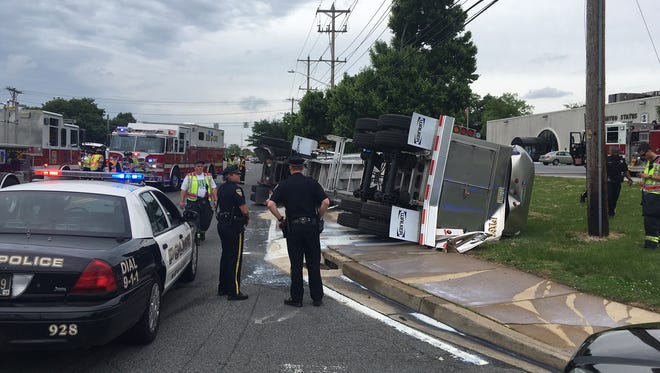 Police investigate a crash of a tractor-trailer carrying milk at Newark Road and Library Avenue in Newark on Monday, May 30, 2016.