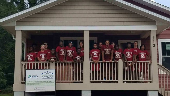 Asheville High football players volunteered their time Saturday for two local charities — Habitat for Humanity and MANNA FoodBank.