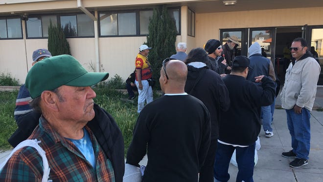 People are seen in this file photo waiting to get into the winter shelter at the Oxnard National Guard Armory. Oxnard is currently looking for property to open a year-round shelter.
