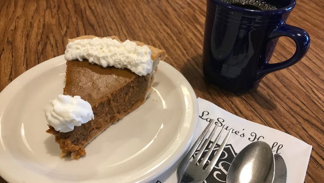 A slice of pumpkin pie from La Sure's Cakes and Catering in Oshkosh, paired with a hot cup of joe.