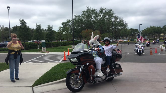 Bob Hotozy, dressed as the Easter bunny, arrives at Golisano Children's Hospital with 220 other Harley Owners Group (HOG) riders to deliver presents to children.