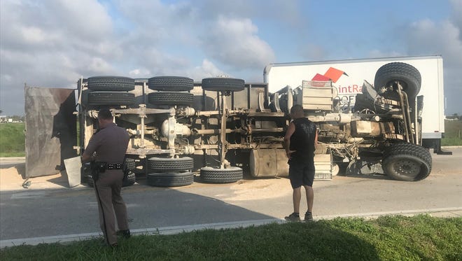 A dump truck turning onto Lee Road from Alico Road overturned, blocking Lee shortly before 8 .m. Monday. The dump truck driver received minor injuries.