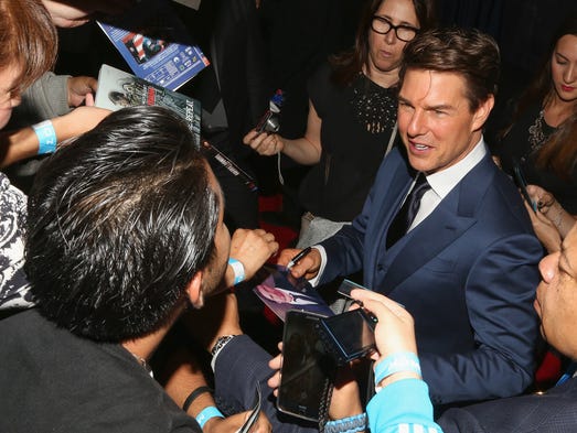 Tom Cruise sign autographs and takes photos with fans