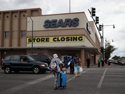 A sign announcing the store will be closing hangs above