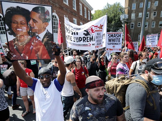 Counter-protesters line the route taken by white nationalists,
