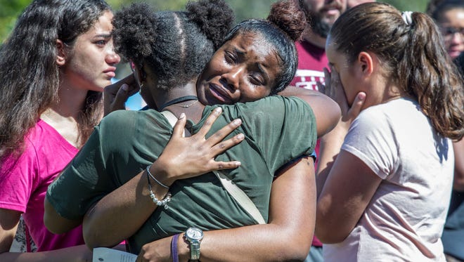 Milan Hamm, center, 17, joins hundreds of community members at a prayer vigil at Parkridge Church in Parkland, FL on February 15, 2018. Members of the community gathered for a vigil for the victims of the mass shooting at Marjory Stoneman Douglas High School.
