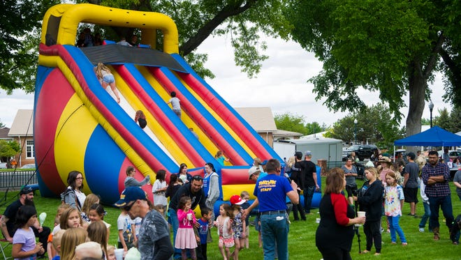 Children play during the Funtime Inflatables fundraiser for Kimberly Simpson in Main Street Park on Monday, May 28, 2018. The money will be used to help pay for Simpson's recent surgery to fix her Chiari Malformation, where her brain stem is squished against her spinal cord.