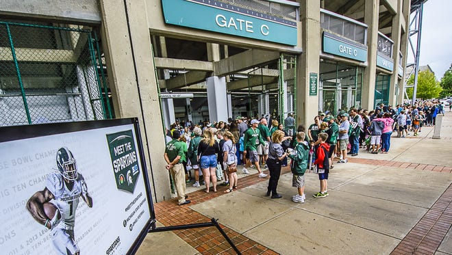 Spartan fans line up around Spartan Stadium for access to MSU football players during the 2014 version of Meet the Spartans Tuesday August 12, 2014 at Spartan Stadium in East Lansing.