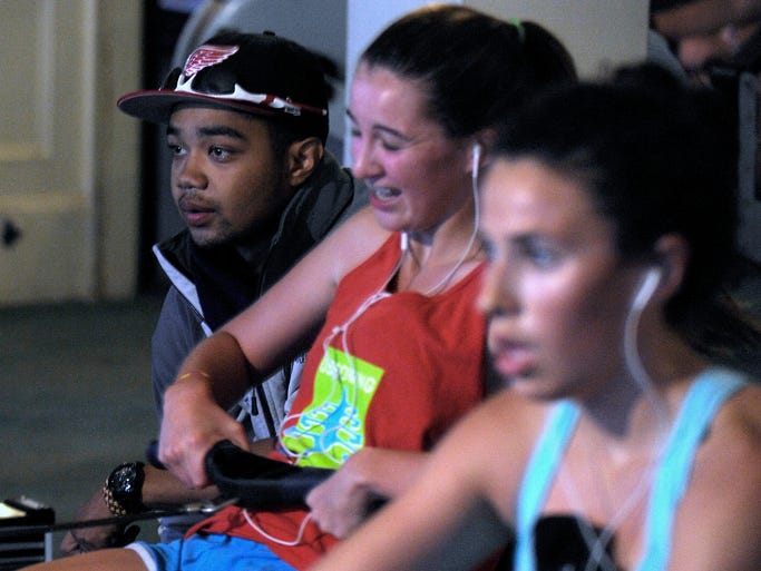 Coach Alijah Dillard, left, 21, of Detroit, watches as Audrey Hass, center, 16, and Erin Ptashnik, right, 15, both of Grosse Pointe Farms, practice. As the Detroit Boat Club Crew celebrates its 175th anniversary, members of the girls and boys teams practice indoors due to inclement weather on Belle Isle, Saturday morning, Oct. 4, 2014.