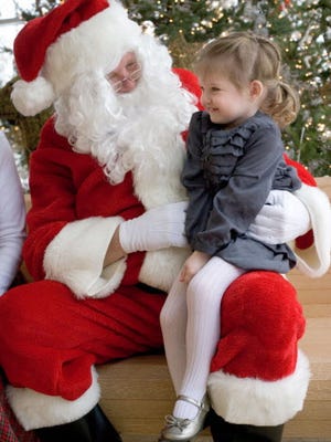 Elizabeth Gigot, 2, of Wauwatosa, shares her holiday wish list with Santa Claus at the Milwaukee County Zoo's Breakfast with Santa.