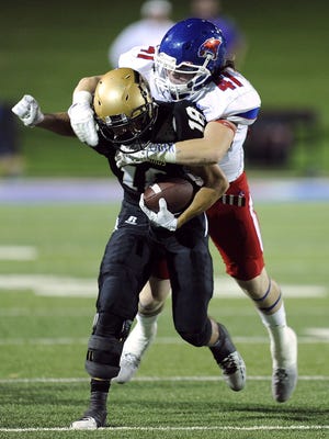 Cooper linebacker Zach Goodson (41) tackles Abilene High wide receiver Bryce McGough (18) during the second quarter of the Eagles' 55-38 win in the crosstown football game on Sept. 9 at Shotwell Stadium.