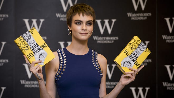 Cara Delevingne attends the signing of her debut novel 'Mirror, Mirror' on Oct. 4, 2017 in London.