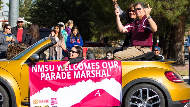 Parade Marshal Jack Nixon shows his Aggie Pride with the guns up salute at the NMSU Homecoming Parade on October 28, 2017.