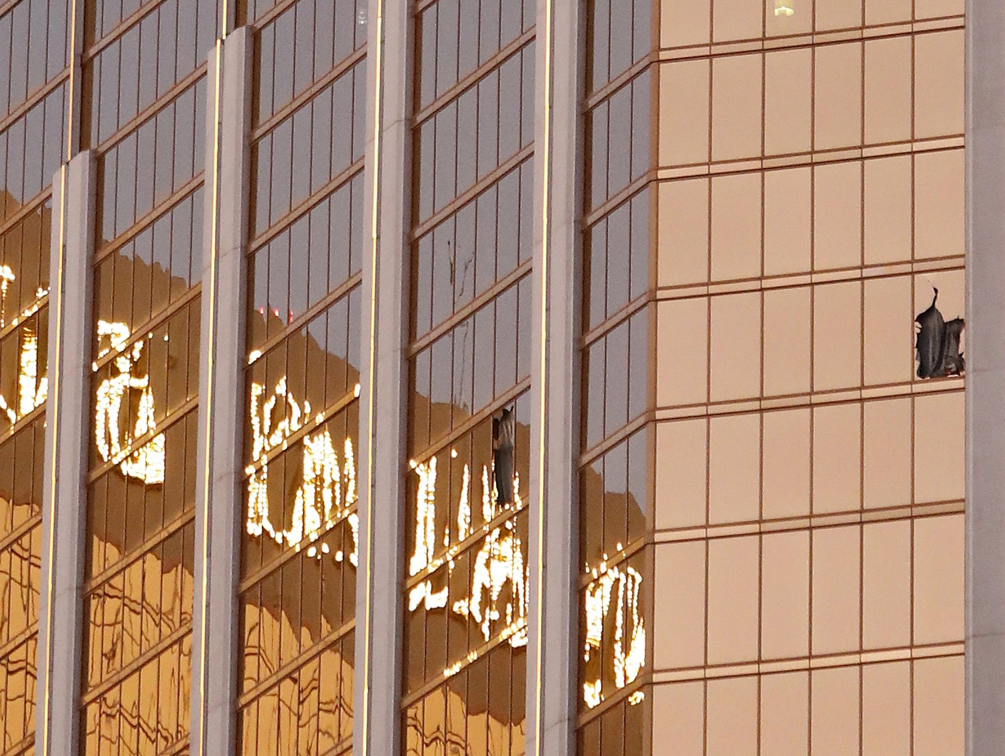Broken windows are seen on a high floor in the Mandalay Bay hotel facing the scene of the mass shooting at the Route 91 Harvest festival in Las Vegas on Monday.