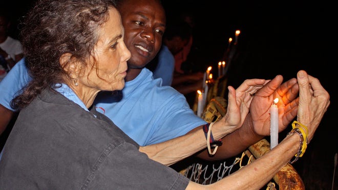 
Julia Alvarez lights a candle at an event commemorating Haitian Massacre of 1937 at the Dominican Republic-Haiti border.
