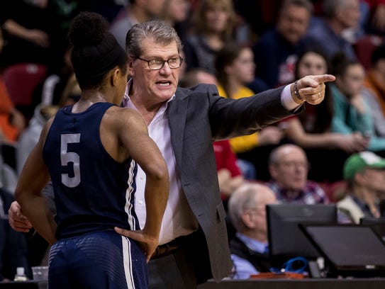 Connecticut's head coach Geno Auriemma, right, instructs