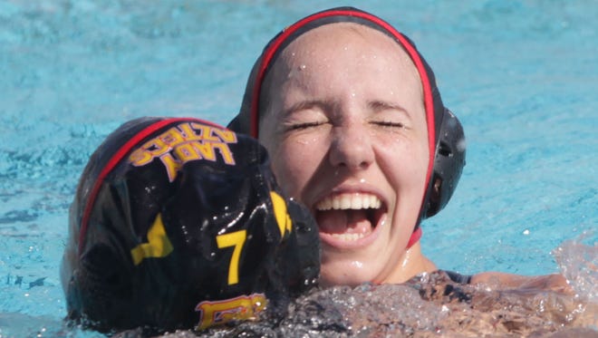 Palm Desert High School's Alissa Clyde, facing front, embraces Elise Stein after winning the CIF Championship match against Temple City at Woollett Aquatics Center in Irvine, California on February 27, 2016.