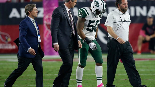 New York Jets outside linebacker Darron Lee (50) leaves the field after being injured during the second half of an NFL football game against the Arizona Cardinals, Monday, Oct. 17, 2016, in Glendale, Ariz. (AP Photo/Ross D. Franklin) 