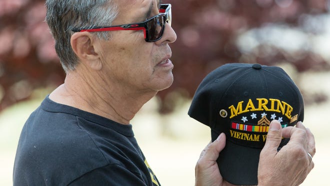 U.S. Marine Corp veteran Richard Sanchez takes his hat off and points to the insignia while talking with his twin brother U.S. Navy veteran William Sanchez, (not pictured) during the eighth annual Welcome Home Vietnam Veterans event at Veterans Memorial Park on Saturday, March 31, 2018. The twins served in Vietnam together.