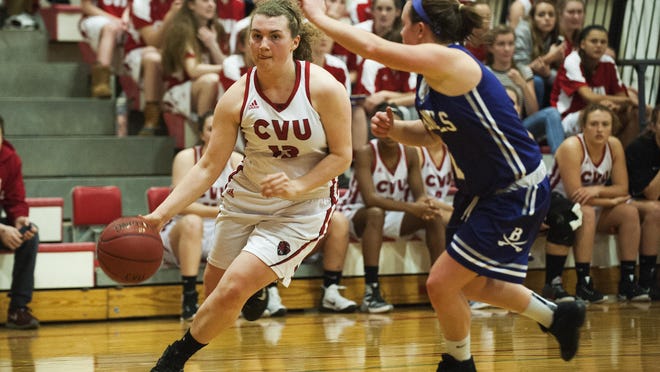 CVU's Marlee Gunn (13) drives to the hoop past Brattleboro's Devin Millerick (2) during the girls basketball game between the Brattleboro Colonels and Champlain Valley Union Redhawks on Thursday night.