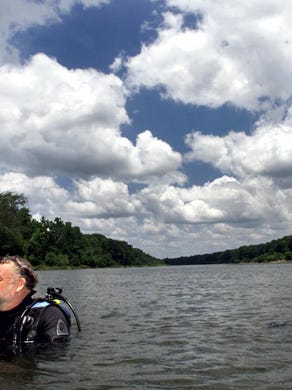 State underwater archeologist Roger Smith, left, and FSU graduate student Bert Ho take a break while searching for artifacts at a site on the Apalachicola River. (2002)