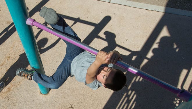 Nathaniel Holguin, 5, attempts to hang from the jungle gym at the Frank O'Brien Papen Community Center, Tuesday March 20, 2018, during the Spring Break Camp organized by the City of Las Cruces Parks and Recreation Department.