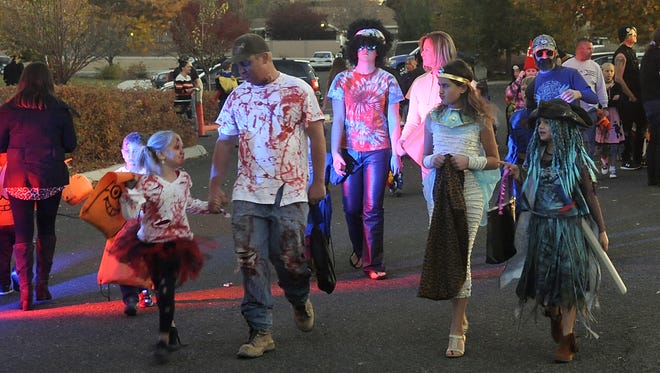 Trick-or-treaters walk to the Fernley Spooktacular.