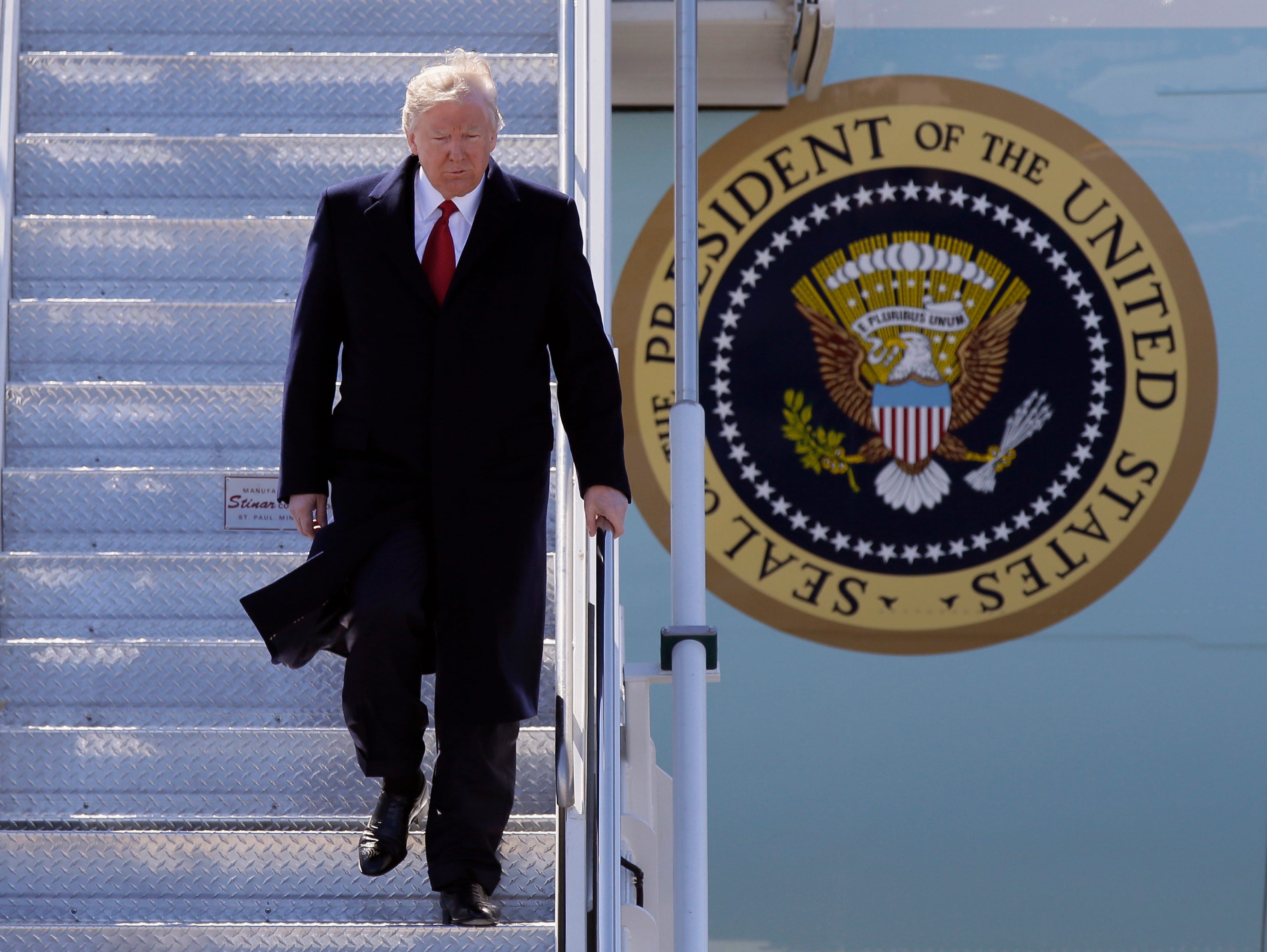 President Trump walks down the steps of Air Force One upon his arrival at Detroit Metropolitan Airport on March 15, 2017, in Romulus, Mich.
