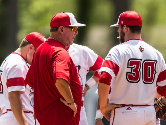 UL head coach Tony Robichaux meets on the hill with pitcher Hogan Harris (30) on April 15, 2017.