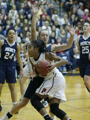 Penfield's Makaila Wilson runs around Mercy's Leah Koonmen in the second quarter at Pittsford Sutherland High School