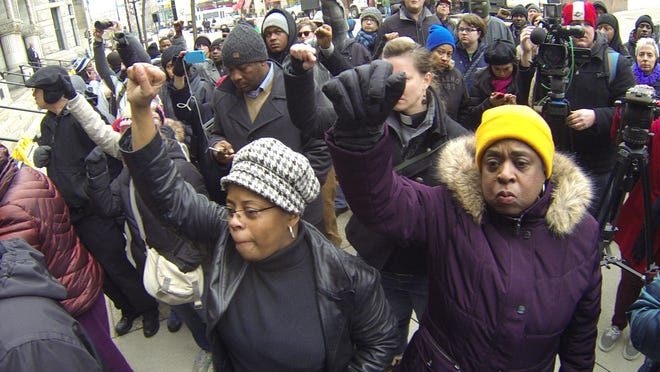 Protestors march in Milwaukee Monday, Dec. 22, 2014 after authorities announced a white Milwaukee police officer who fatally shot a mentally ill black man in April won't face criminal charges. Milwaukee County District Attorney John Chisholm said Christopher Manney won't be charged because he shot Dontre Hamilton in self-defense.