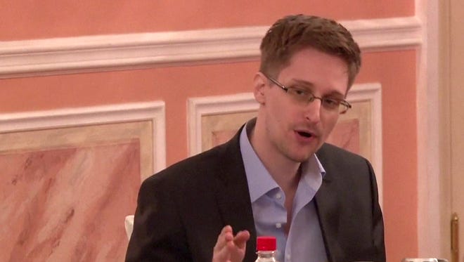 A frame grab made from AFPTV footage, reportedly taken on October 9, 2013, shows US intelligence leaker Edward Snowden speaking during his dinner with a group of four retired US ex-intelligence workers and activists at a luxurious room in an unidentified location.