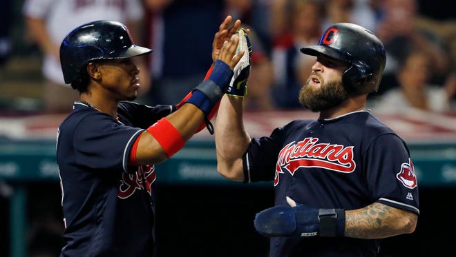 Cleveland Indians' Mike Napoli, right, and Francisco Lindor celebrate after scoring on a double by Jose Ramirez off Minnesota Twins relief pitcher J.T. Chargois during the fifth inning of a baseball game Wednesday in Cleveland.