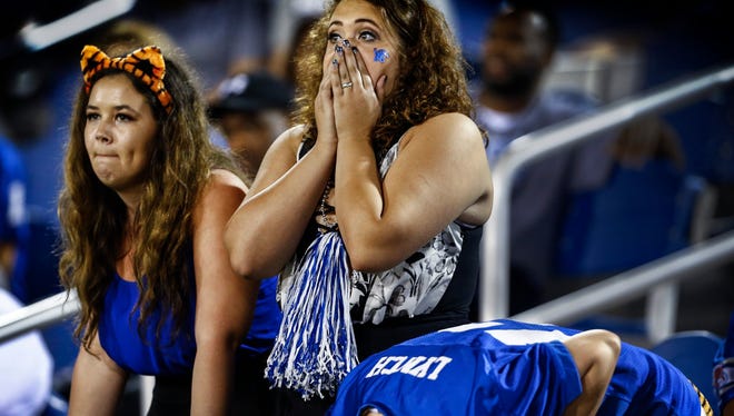   Dejected University of Memphis students Mackenzie White (left) Faith Orr (middle) and Leanna Ritter (bent over) react after the TigersÕ defense was called for delay of game on fourth down against Western Kentucky University late in the fourth quarter action of the Boca Raton Bowl in Florida. Memphis loss the game 51-31 and fell to 8-5 on the season. 