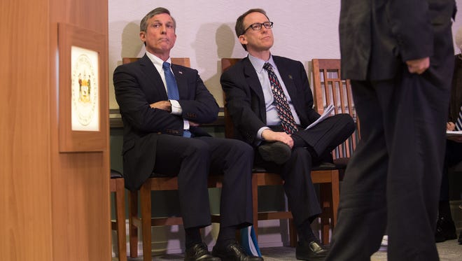 Gov. John Carney, left, and Finance Secretary Rick Geisenberge listen as Mike Jackson, director of the Delaware Office of Management and Budget, gives his presentation on the state budget last March.