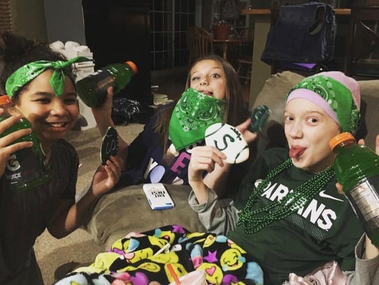 McKenna Schummer, right, passed away March 6 after a two-year fight with bone cancer. The 11-year-old was a hardcore MSU fan who drank green Gatorade while watching games. Miles Bridges dedicates this season to her.