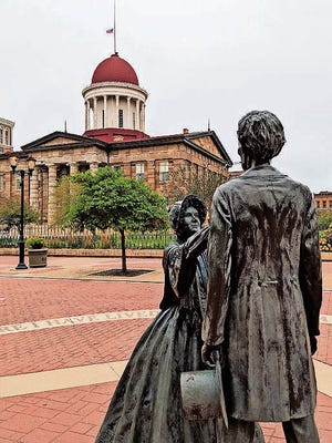 A statue of Abraham Lincoln and his wife, Mary Todd Lincoln, outside the Old State Capitol.