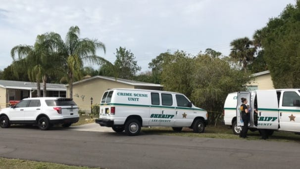 Members from the Lee County Sheriff's Office crime scene unit prepare to enter 15636 Royal Coach Circle where two bodies were found on Sunday.
