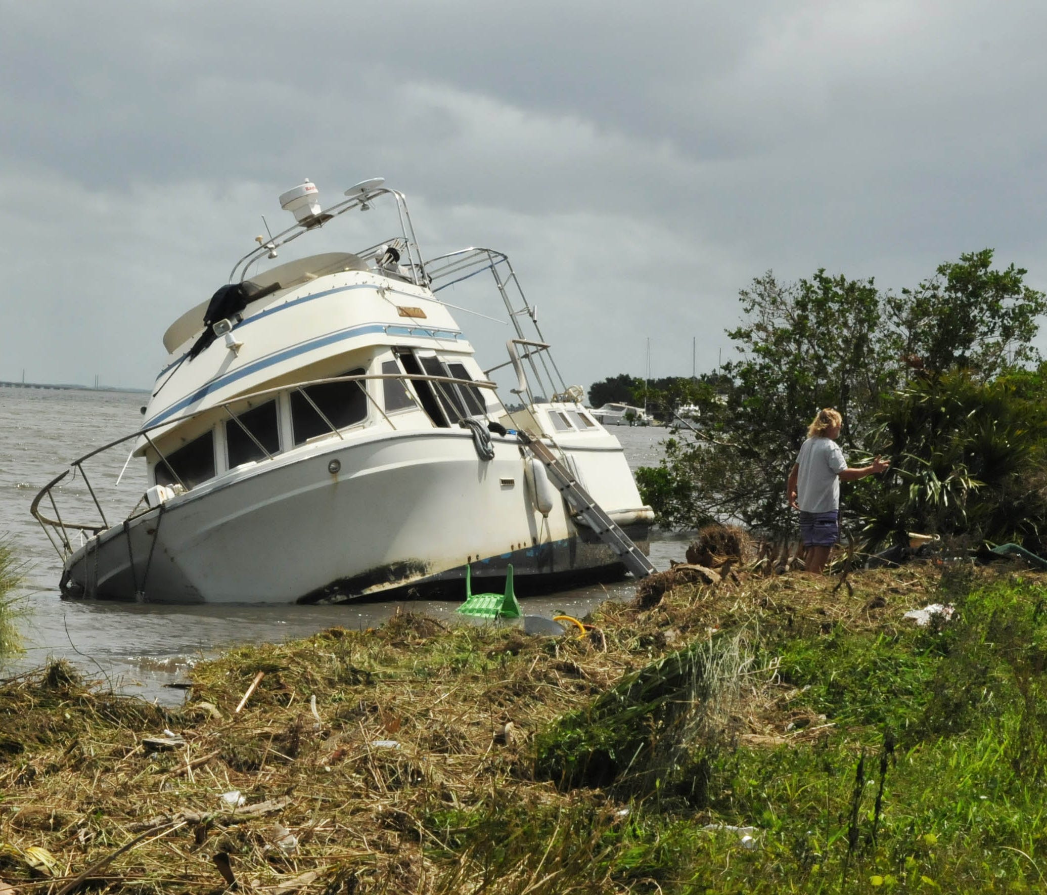 A boat, whose owner ran it aground  to have a chance at saving it before it sunk during Hurricane Irma sits on shore in Titusville, Fla.